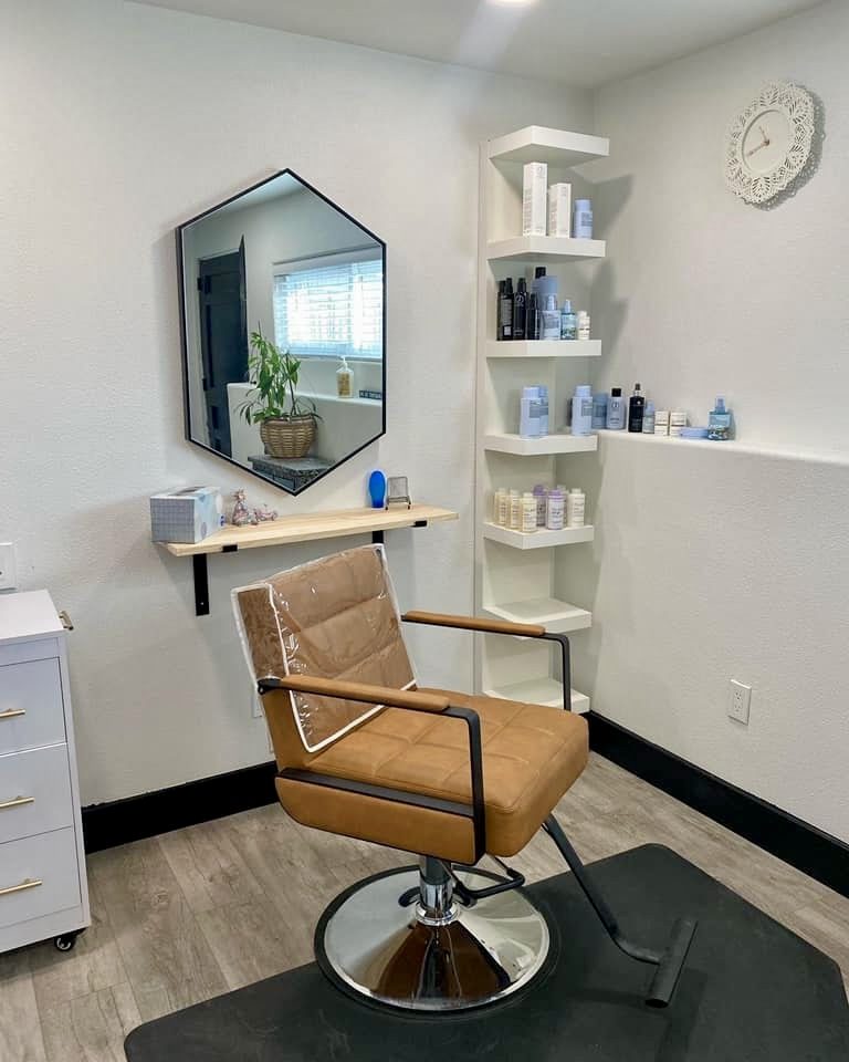 Salon styling suite with a wall-mounted mirror, floating timber shelf and built-in retail shelving