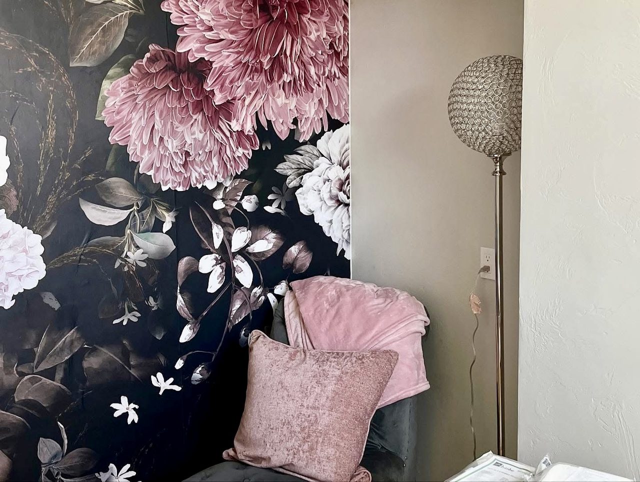Treatment room with a dark floral feature wall and soft lighting