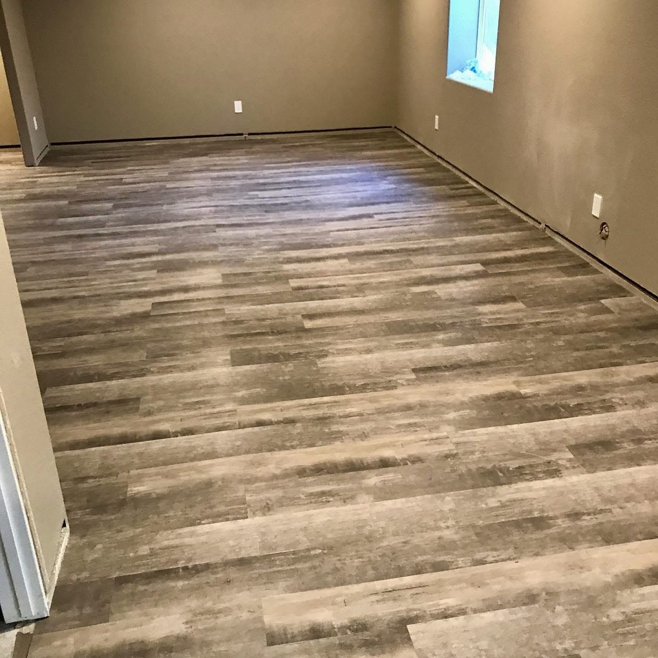 Luxury vinyl plank flooring newly installed in an empty room