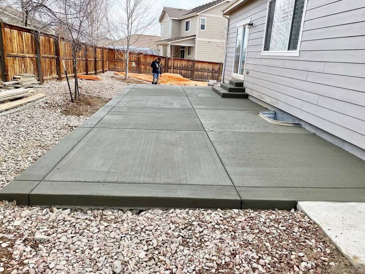 Newly poured concrete patio slab alongside the house